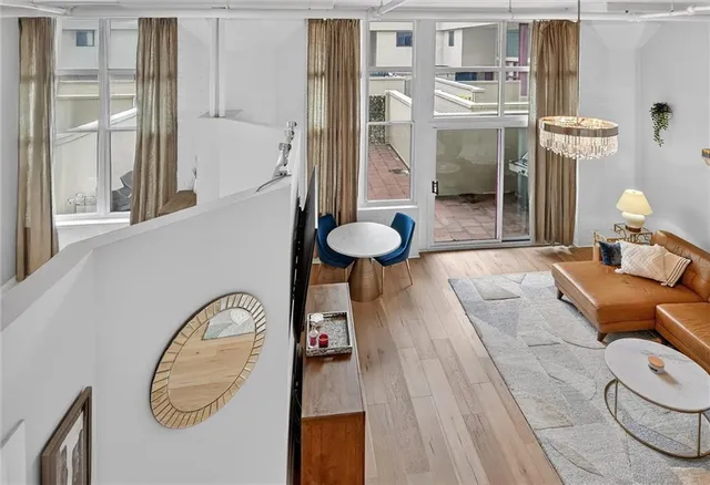 a view of a bedroom with a flesh screen tv and windows