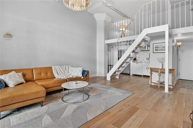a living room with furniture and stairs