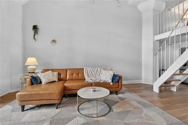 a living room with furniture a rug and a large window