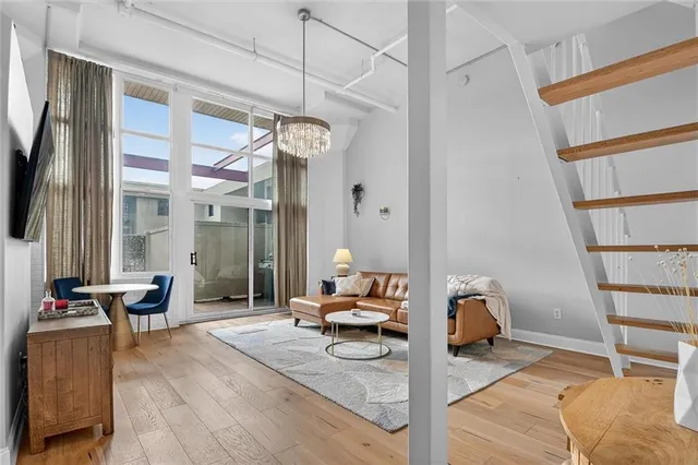a bedroom with furniture and a large window