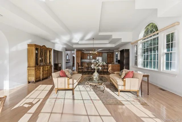a living room with fireplace furniture and a large window