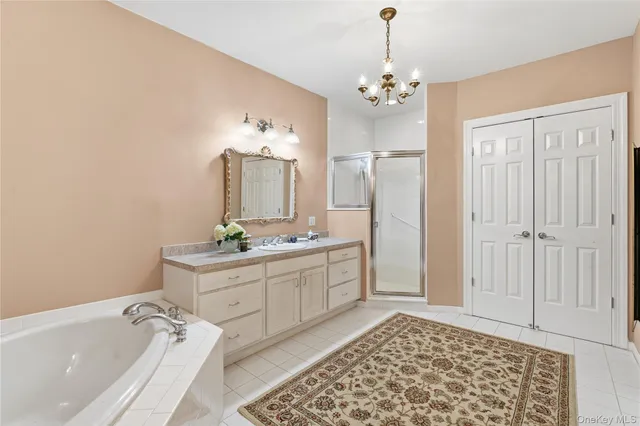 a spacious bathroom with a double vanity sink mirror and shower