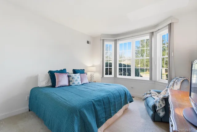a bedroom with two beds and a large window