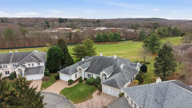 an aerial view of residential houses with outdoor space and river