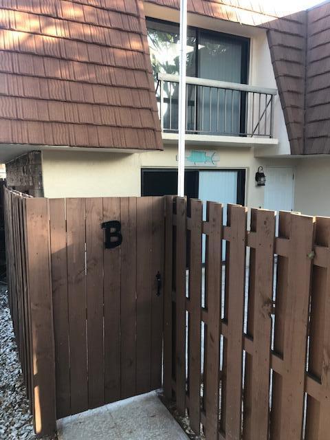 825 Center Street, Unit 1B Jupiter, FL 33458 - Photo 1 of 16 a view of a house with wooden fence