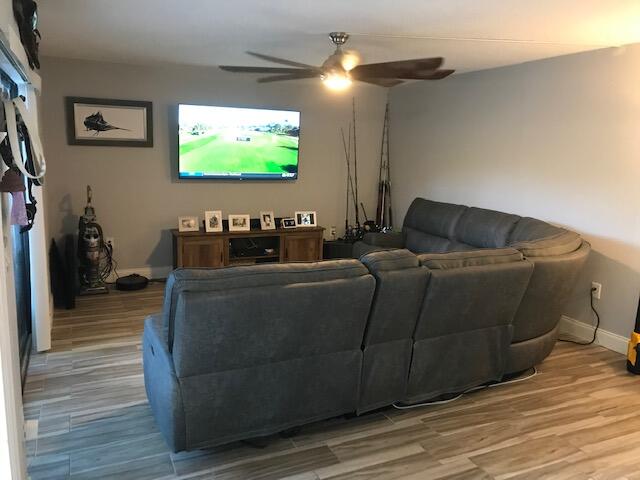 825 Center Street, Unit 1B Jupiter, FL 33458 - Photo 3 of 16 a living room with furniture and a flat screen tv
