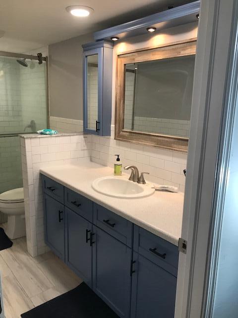 825 Center Street, Unit 1B Jupiter, FL 33458 - Photo 10 of 16 a bathroom with a sink and a mirror