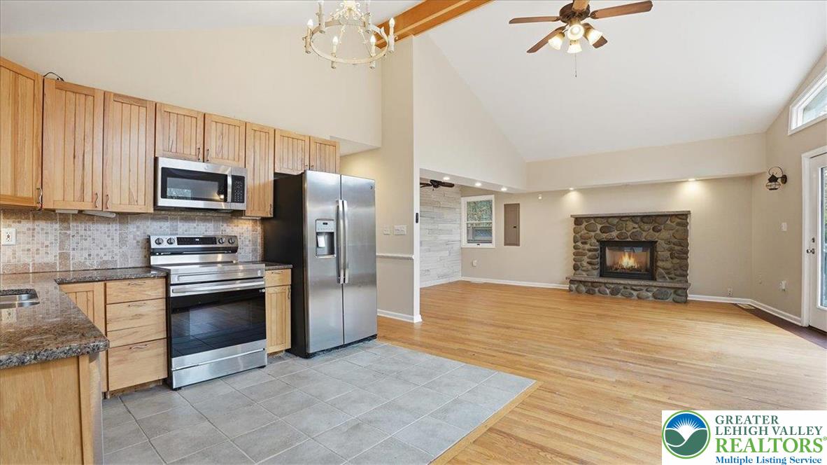 2318 Sunbird Court Scotrun, PA 18355 - Photo 14 of 56 a kitchen with granite countertop a stove cabinets and stainless steel appliances