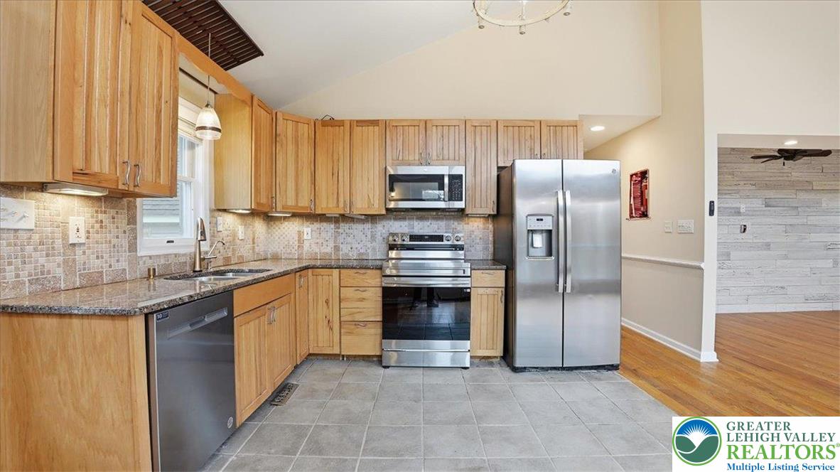 2318 Sunbird Court Scotrun, PA 18355 - Photo 15 of 56 a kitchen with granite countertop a refrigerator and a sink