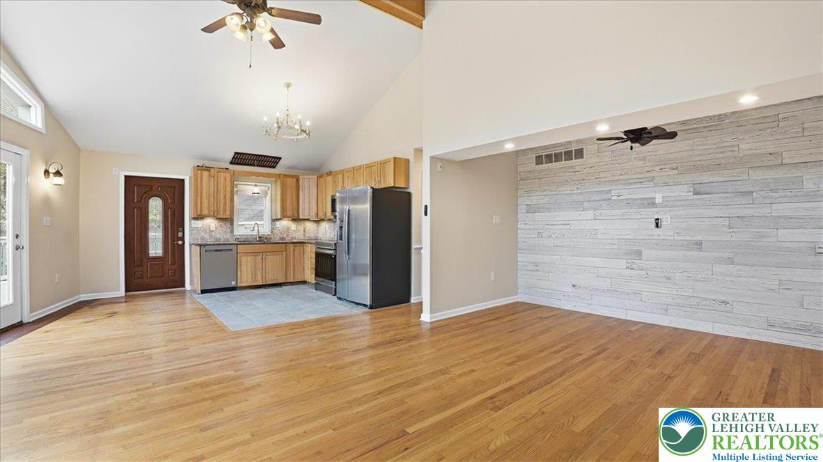 2318 Sunbird Court Scotrun, PA 18355 - Photo 18 of 56 a view of a kitchen with a refrigerator a microwave and a wooden floor