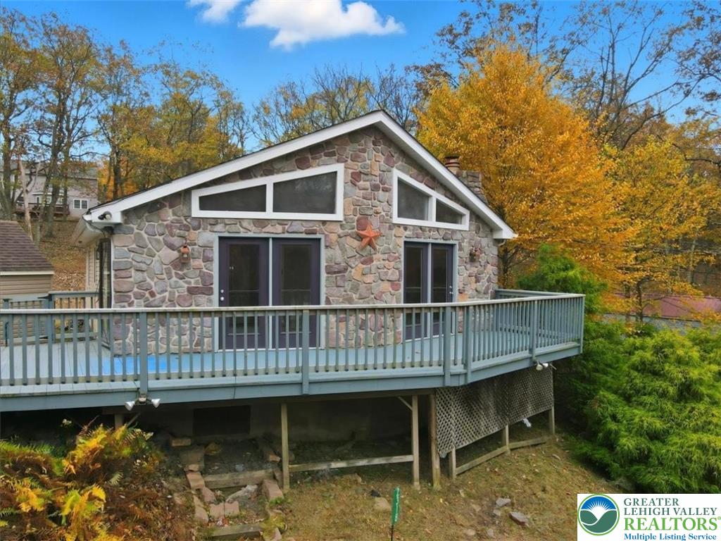2318 Sunbird Court Scotrun, PA 18355 - Photo 2 of 56 a view of a house with a wooden deck and furniture
