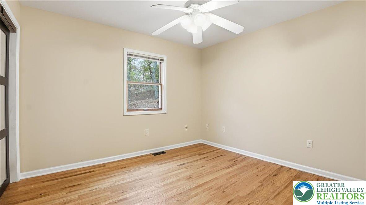 2318 Sunbird Court Scotrun, PA 18355 - Photo 24 of 56 an empty room with wooden floor fan and windows