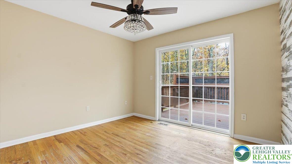 2318 Sunbird Court Scotrun, PA 18355 - Photo 26 of 56 an empty room with wooden floor fan and windows