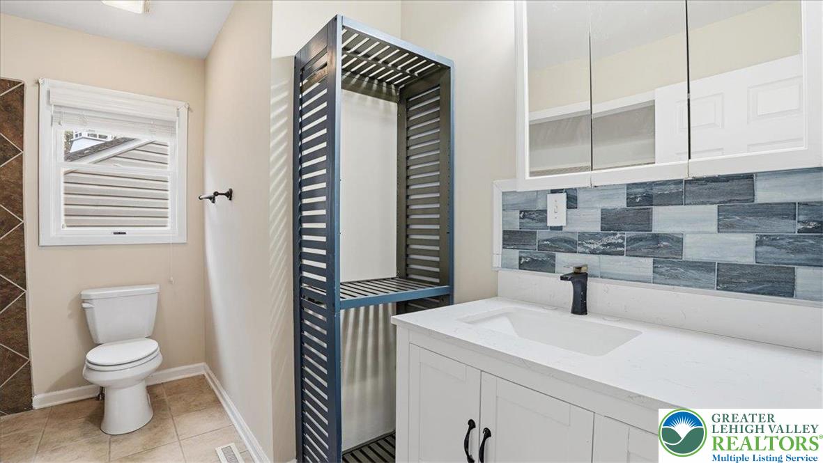 2318 Sunbird Court Scotrun, PA 18355 - Photo 28 of 56 a bathroom with a sink a toilet and mirror