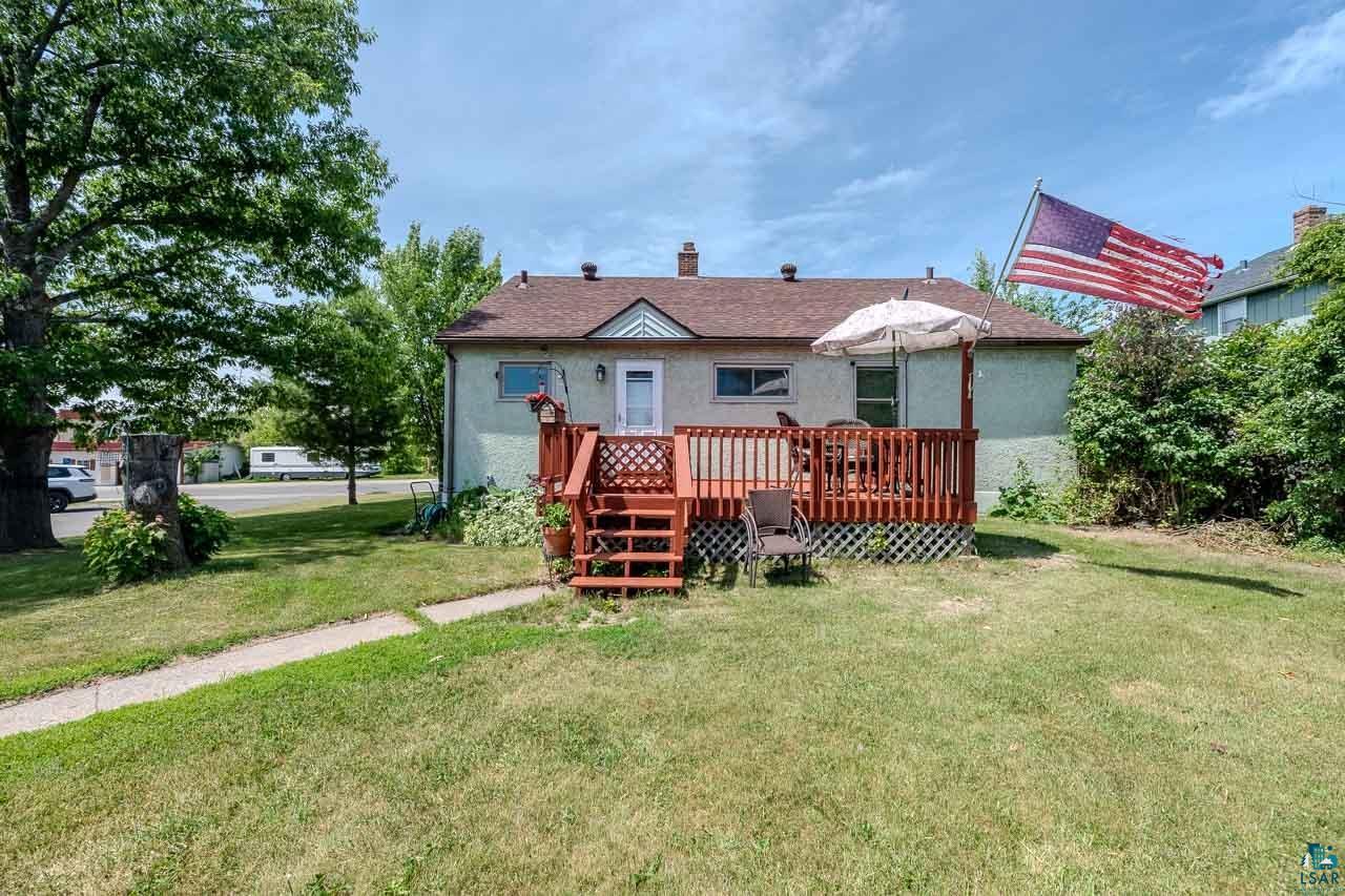 101 2nd Avenue North Biwabik, MN 55708 - Photo 37 of 44 Rear exterior with a wood deck, steps, and lattice skirting