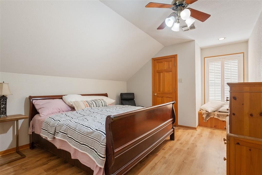 564 Sam Bass Road McGregor, TX 76657 - Photo 20 of 37 Room featuring wood-finish flooring, a sloped ceiling, and a ceiling fan with integrated lighting