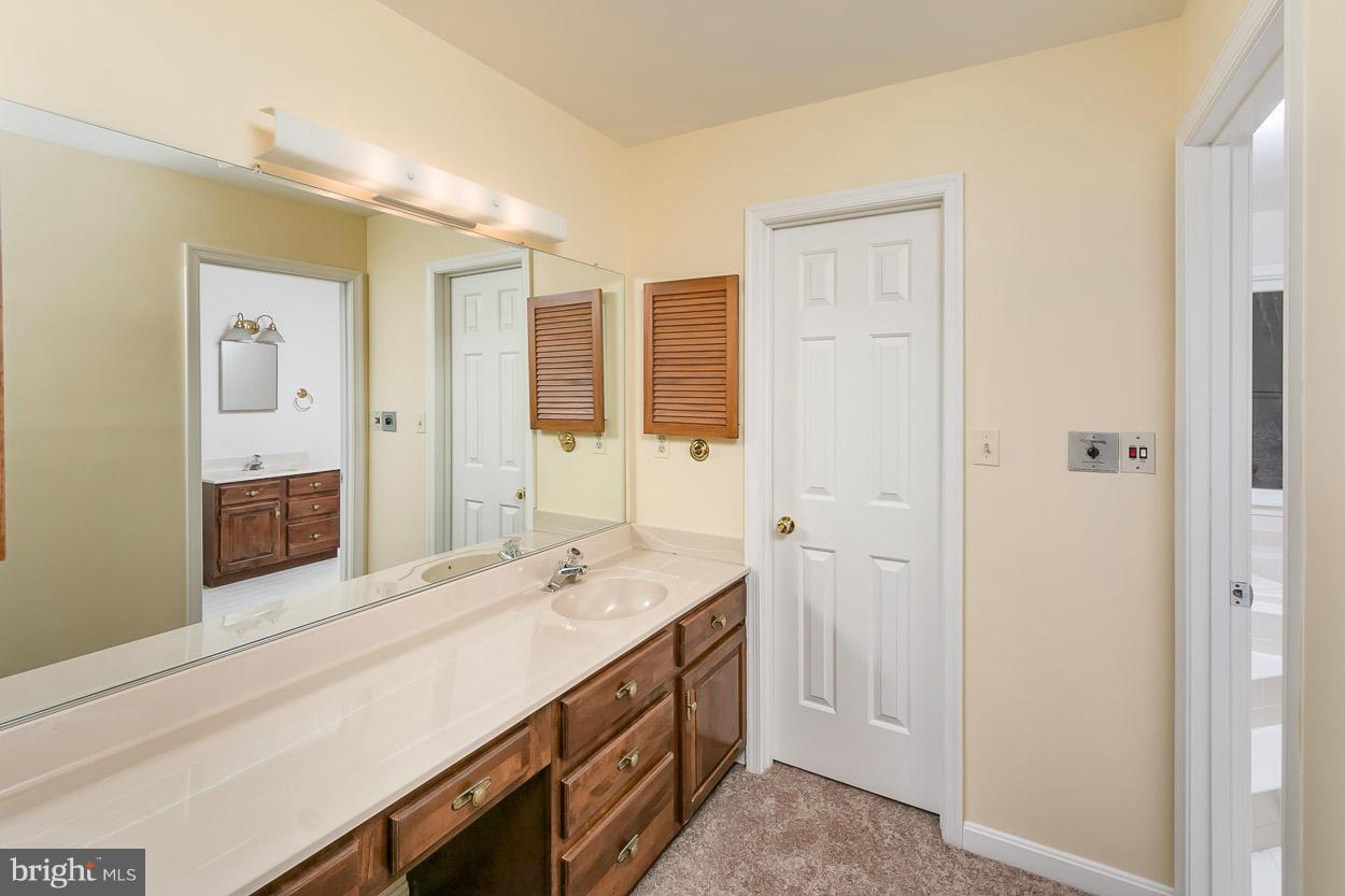 15710 Yeoho Road Sparks, MD 21152 - Photo 22 of 30 a spacious bathroom with a double vanity sink a mirror and a shower