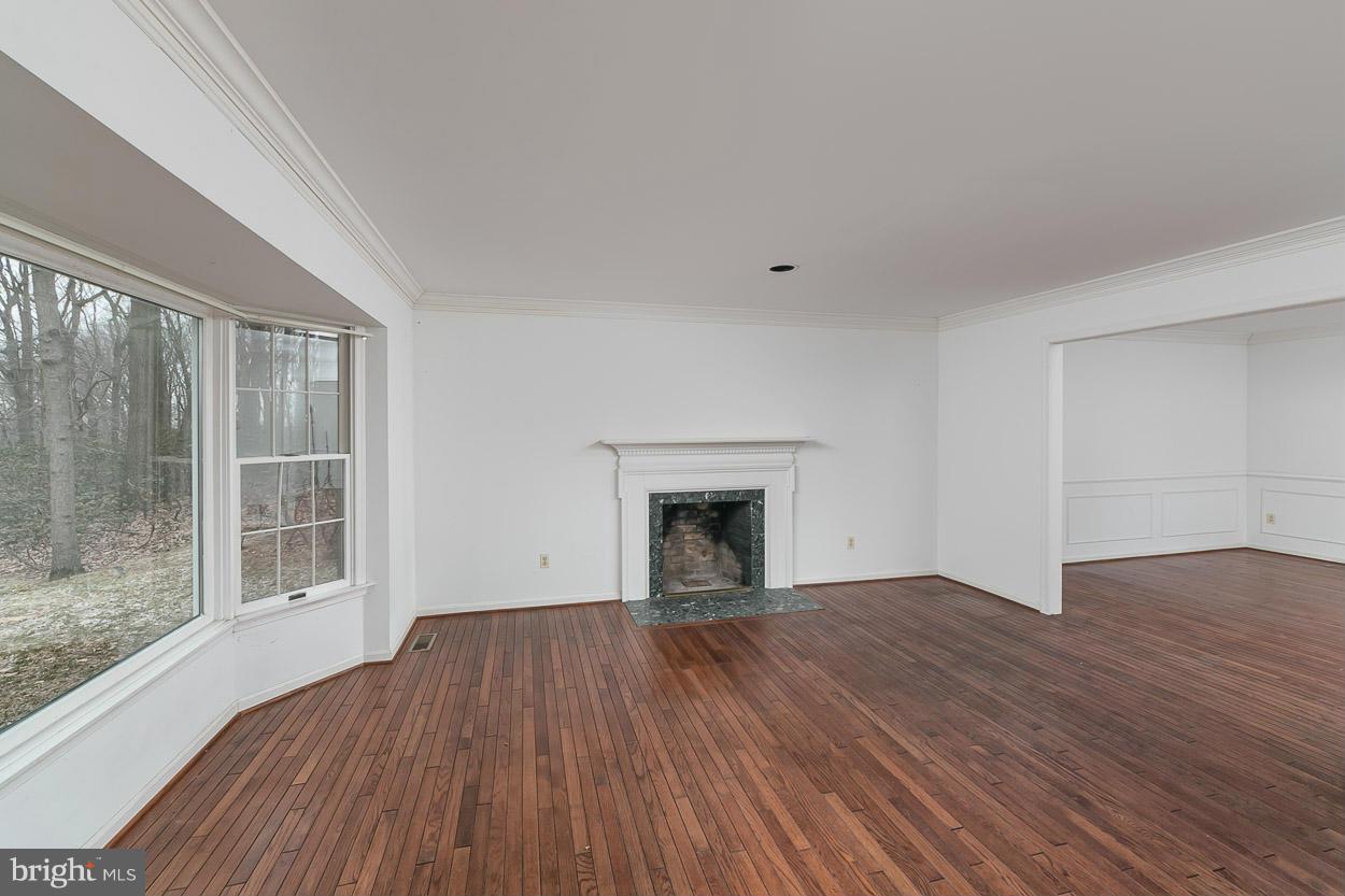 15710 Yeoho Road Sparks, MD 21152 - Photo 5 of 30 a view of empty room with wooden floor and fireplace