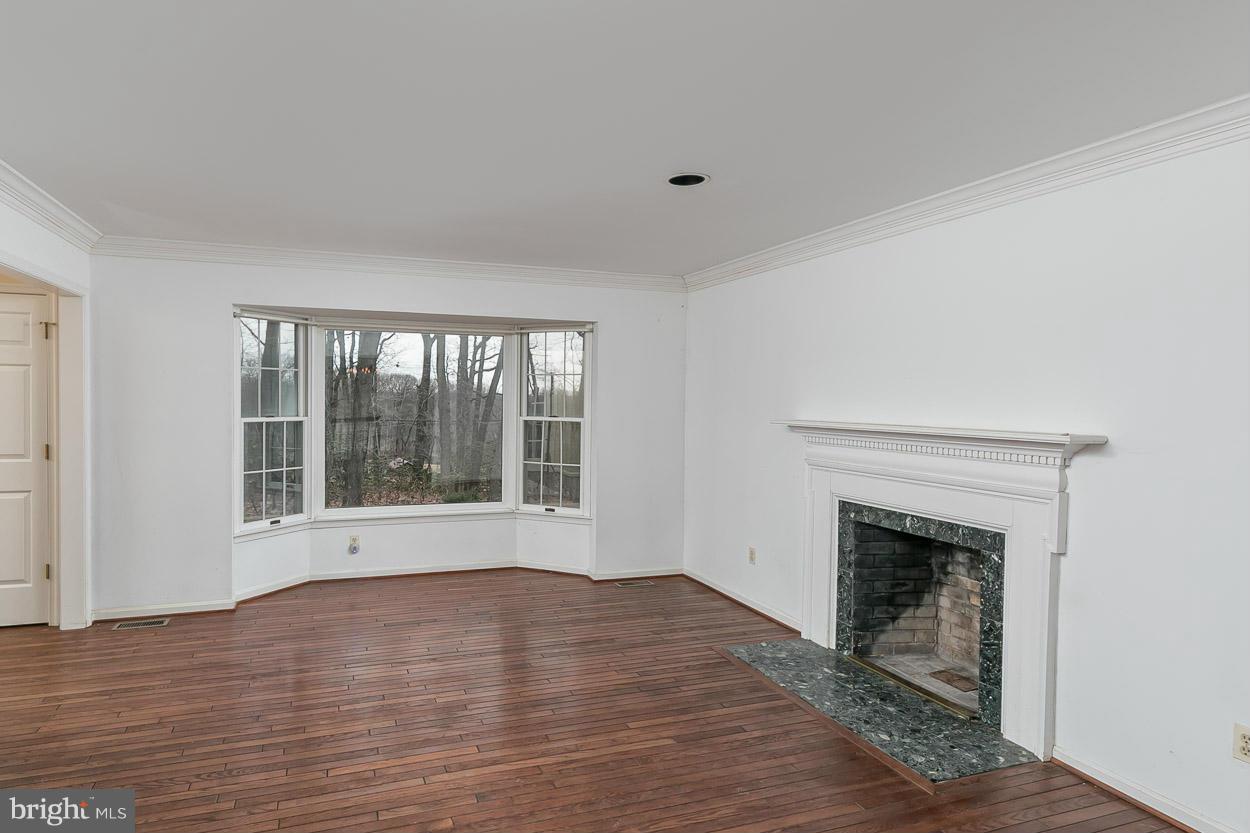 15710 Yeoho Road Sparks, MD 21152 - Photo 6 of 30 a view of an empty room with wooden floor and a window