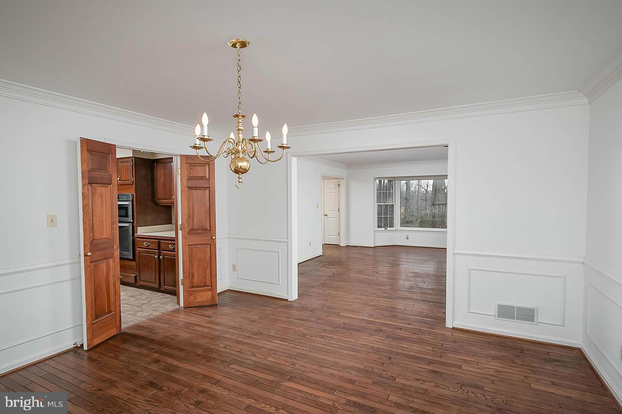 15710 Yeoho Road Sparks, MD 21152 - Photo 7 of 30 a view of a livingroom with a chandelier wooden floor and a chandelier