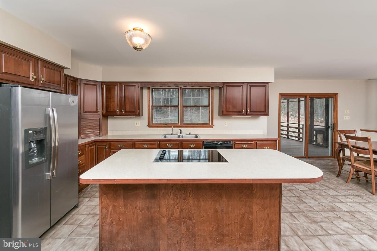 15710 Yeoho Road Sparks, MD 21152 - Photo 8 of 30 a kitchen with stainless steel appliances granite countertop a sink stove refrigerator and microwave