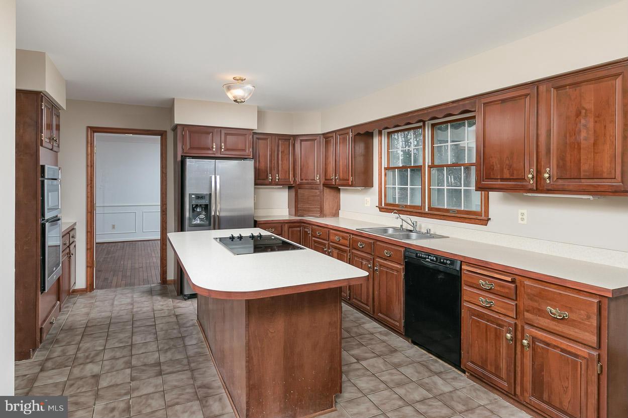 15710 Yeoho Road Sparks, MD 21152 - Photo 9 of 30 a kitchen with a sink stove and cabinets