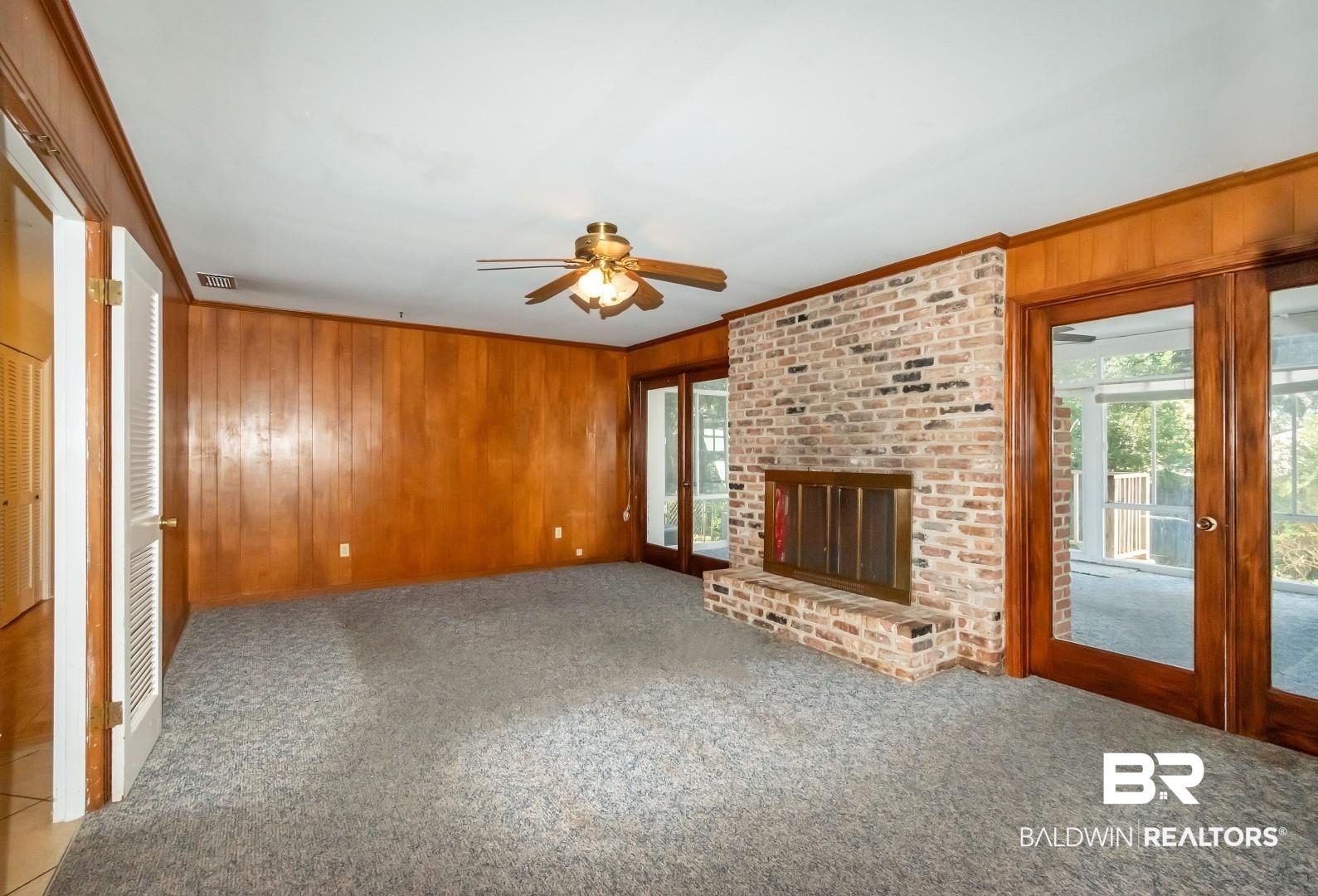 4543 Kingsway Drive Mobile, AL 36608 - Photo 6 of 28 Family room with carpet floors, a fireplace, crown molding, and wood walls