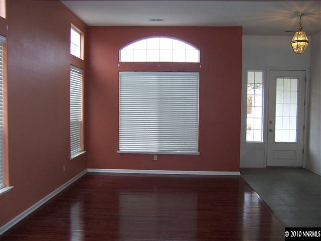4819 Elkcreek Trail Reno, NV 89519 - Photo 5 of 9 an empty room with wooden floor and windows