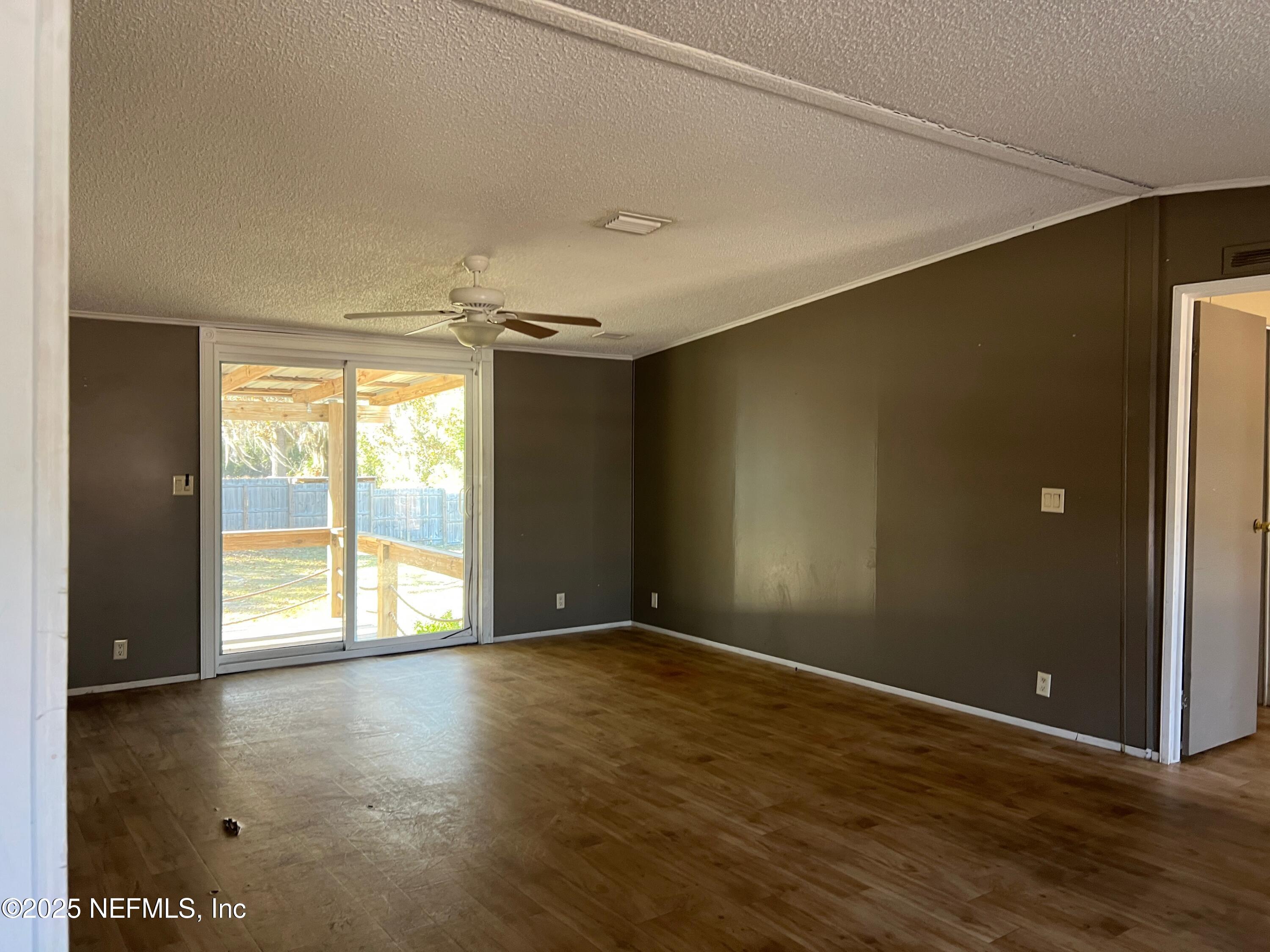 323 Incline Road Satsuma, FL 32189 - Photo 6 of 12 wooden floor in an empty room with a window