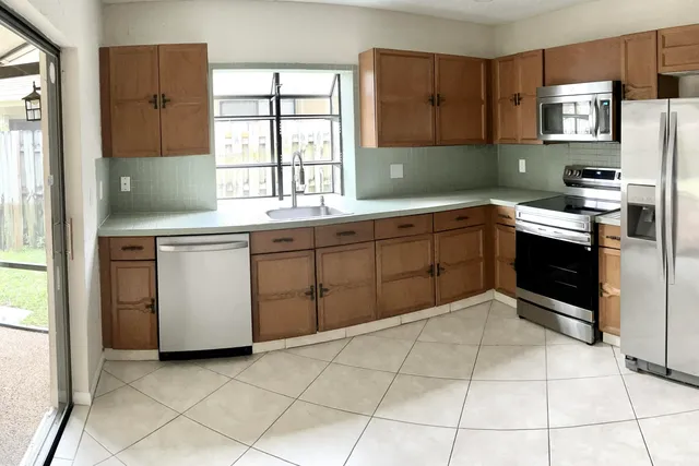 a kitchen with a sink a stove and cabinets