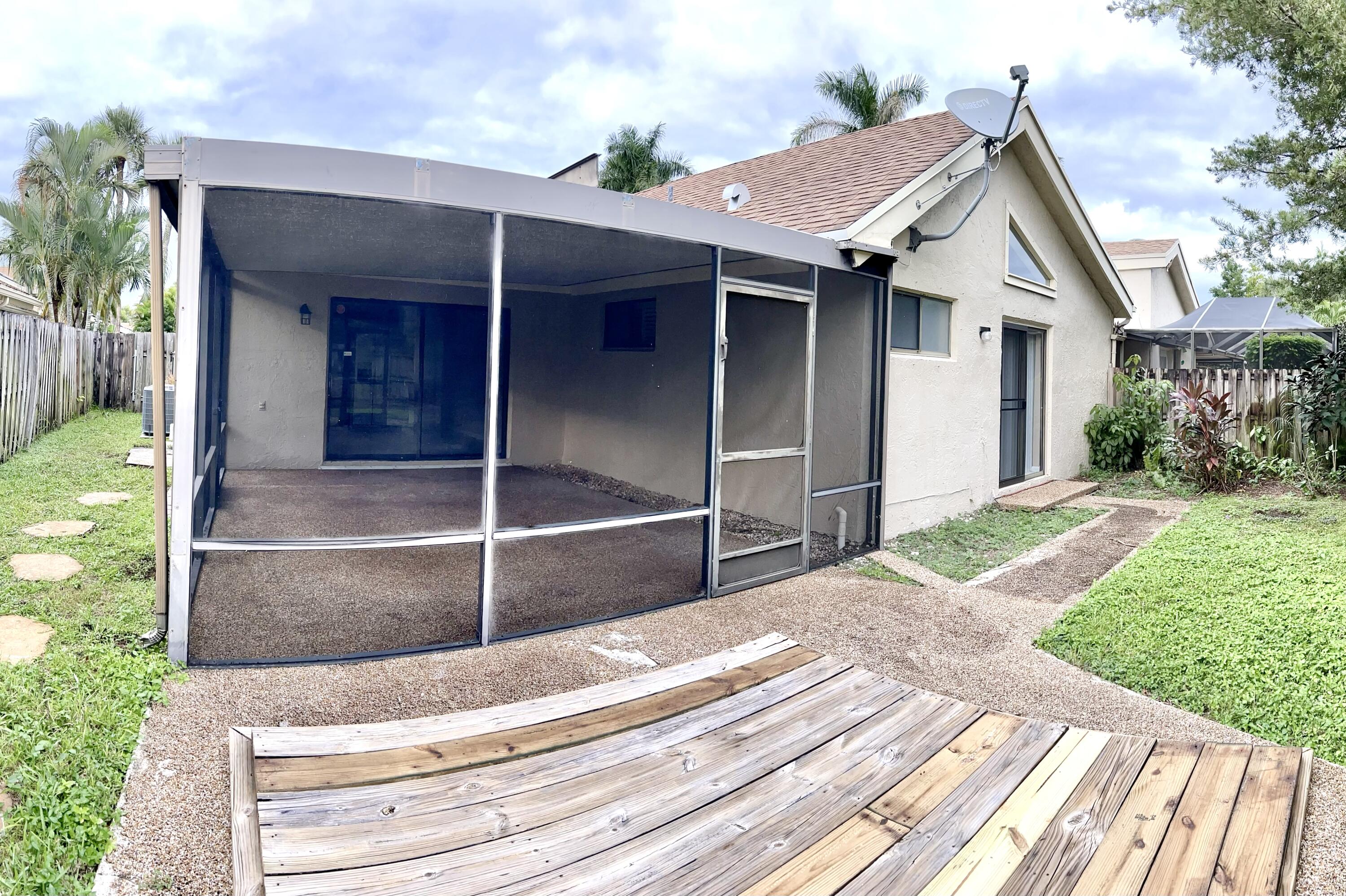 7614 Sierra Terrace West Boca Raton, FL 33433 - Photo 17 of 20 a view of house with backyard