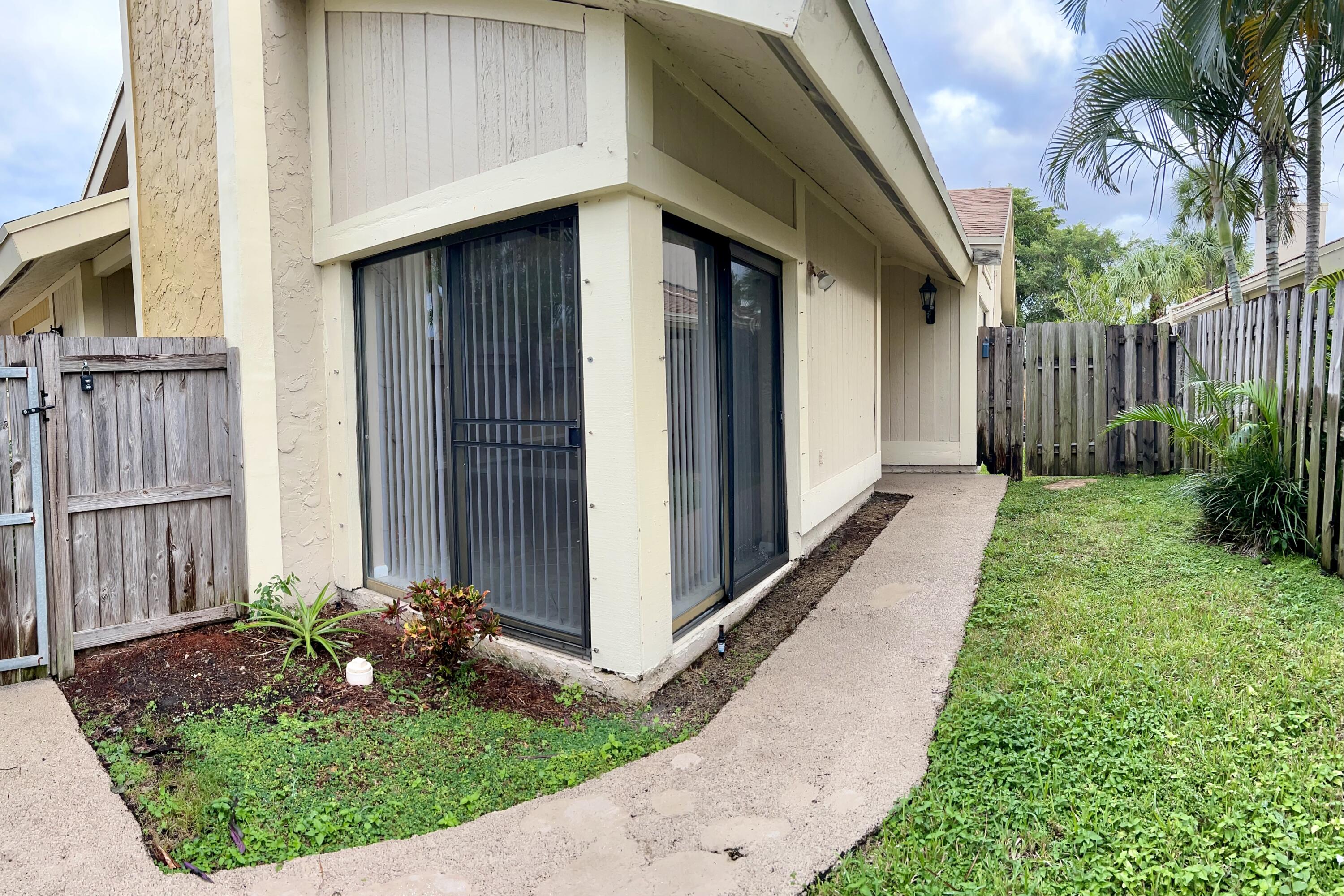 7614 Sierra Terrace West Boca Raton, FL 33433 - Photo 18 of 20 a front view of a house with garden