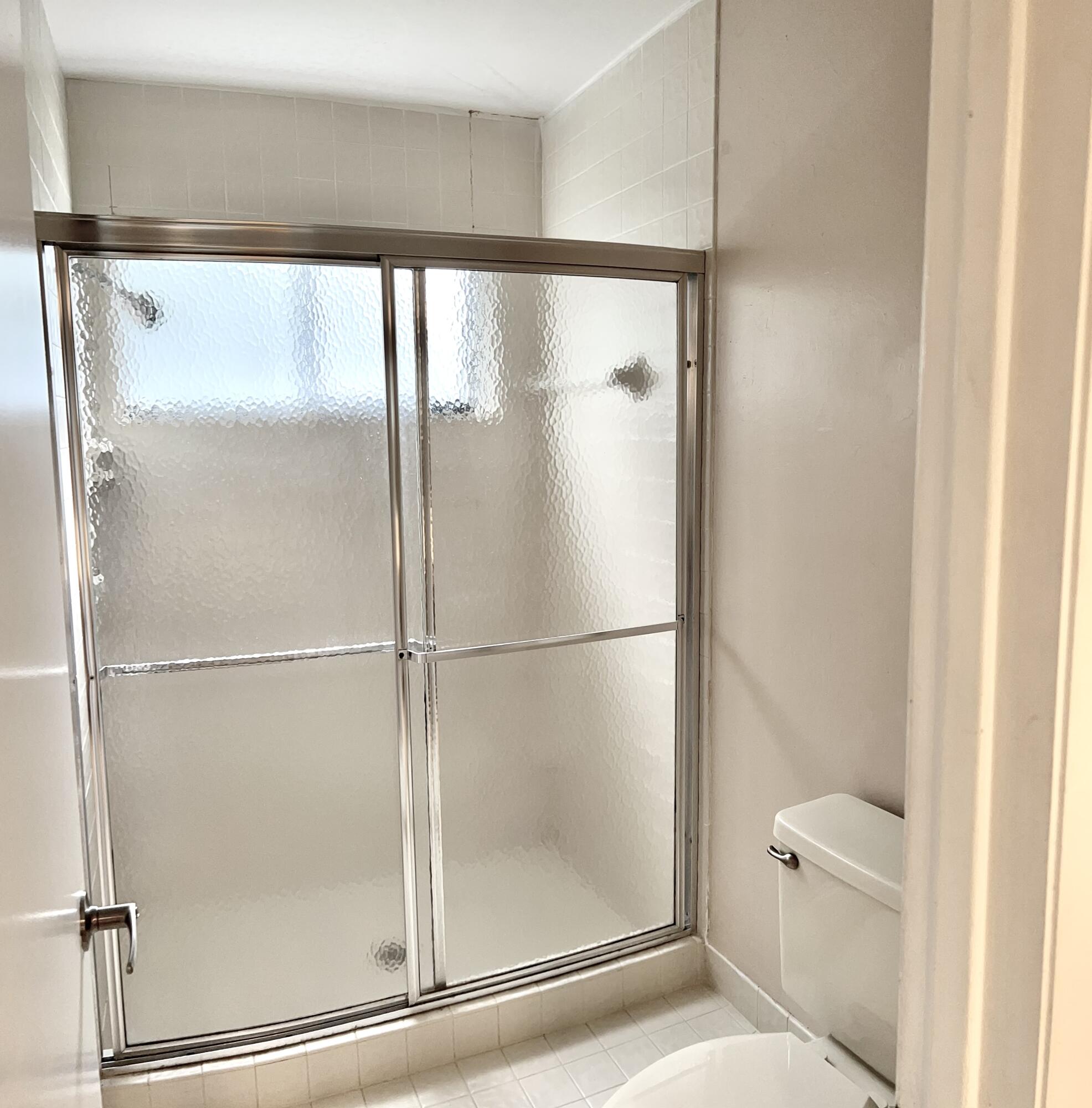 7614 Sierra Terrace West Boca Raton, FL 33433 - Photo 9 of 20 a bathroom with a glass shower door