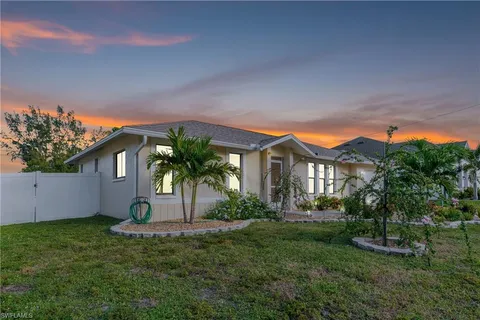 a front view of house with yard and green space
