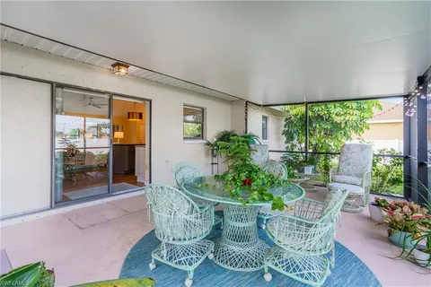 a dining room with furniture and a potted plant