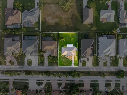 an aerial view of a house with a yard
