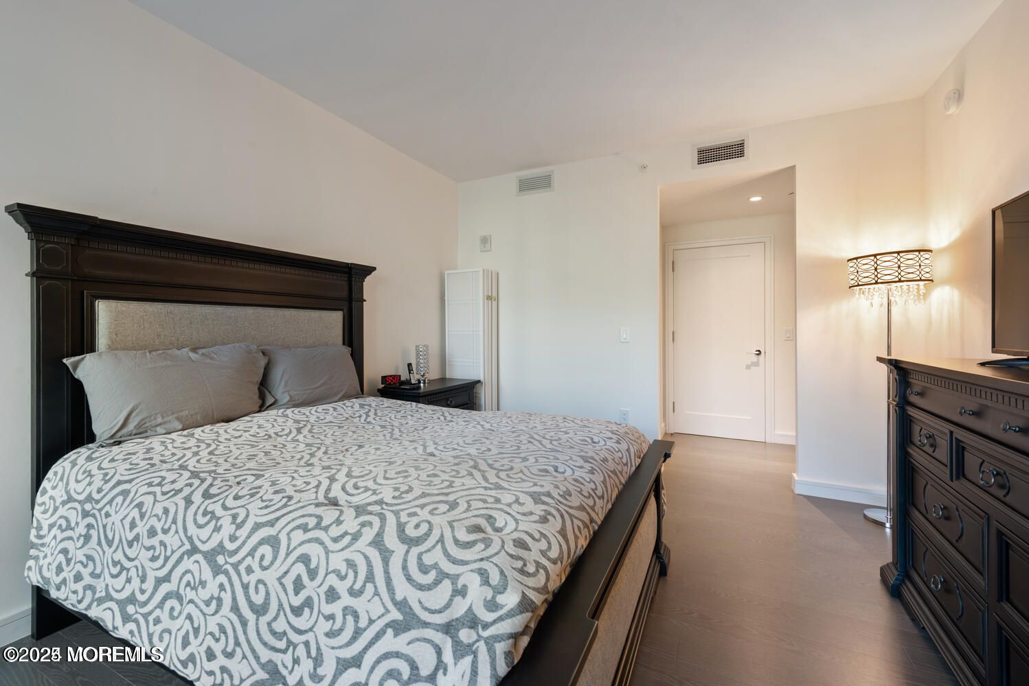 15 Morris Avenue, Unit 308 Long Branch, NJ 07740 - Photo 18 of 48 a bedroom with a bed and wooden floor