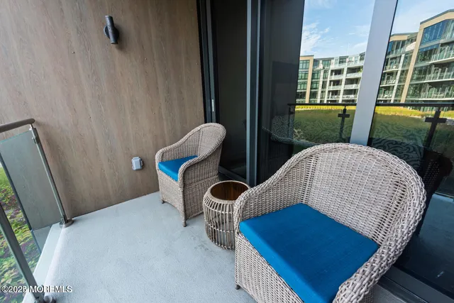 a living room with furniture rug and outdoor view