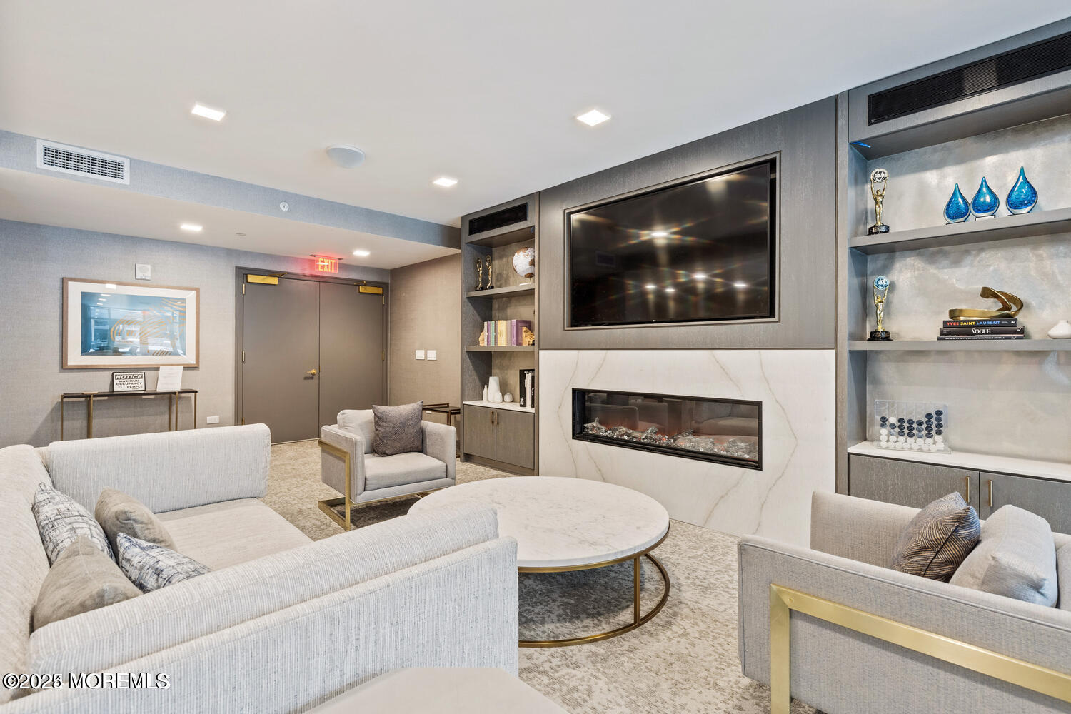 15 Morris Avenue, Unit 308 Long Branch, NJ 07740 - Photo 30 of 48 a living room with furniture a flat screen tv and a fireplace