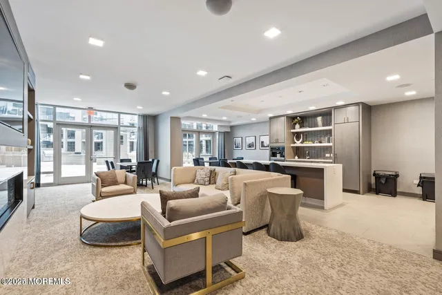 a room with furniture pool table and windows