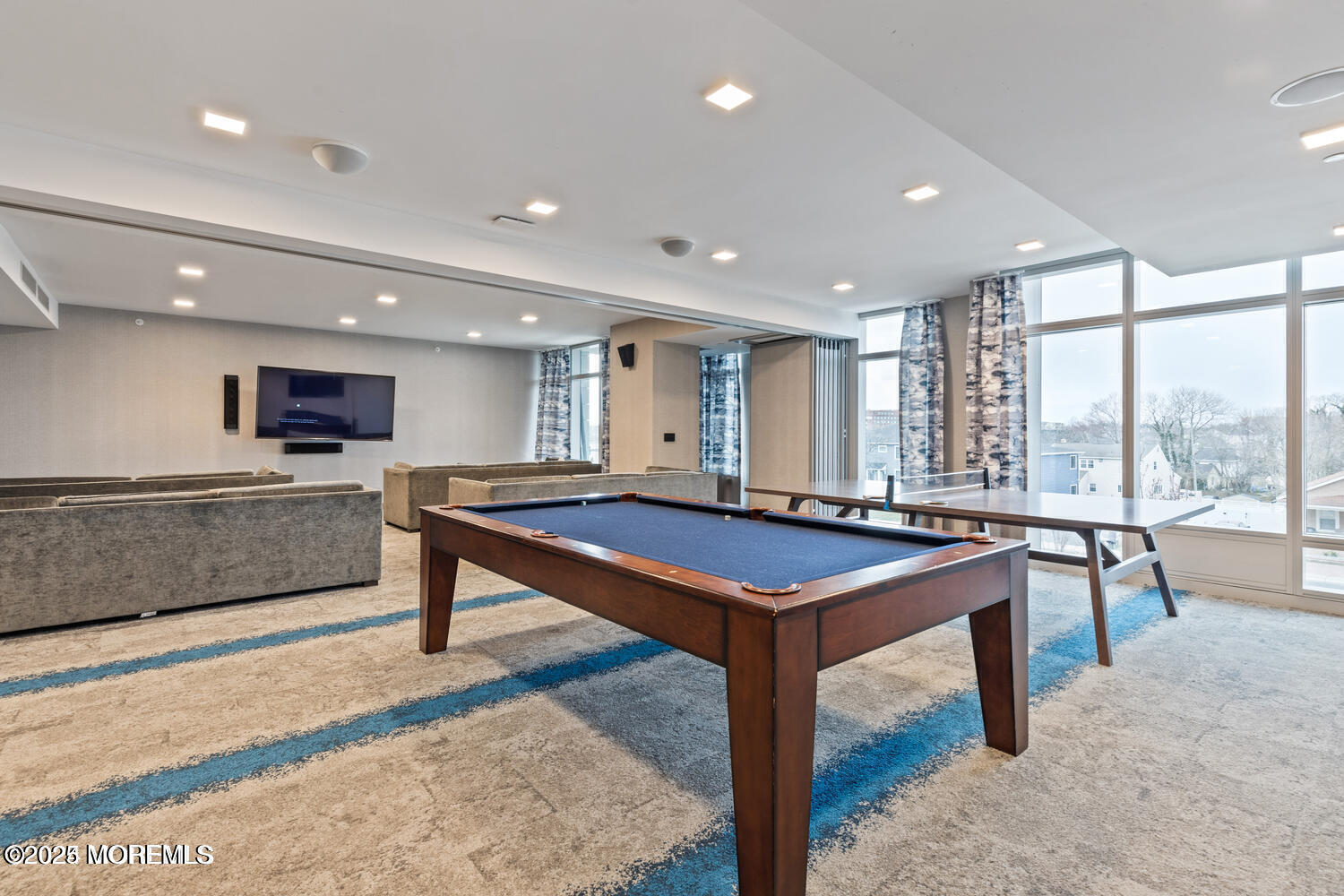 15 Morris Avenue, Unit 308 Long Branch, NJ 07740 - Photo 33 of 48 a room with lots of furniture and a wooden floor