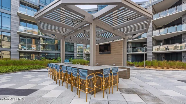 a view of a patio with couches table and chairs and potted plants