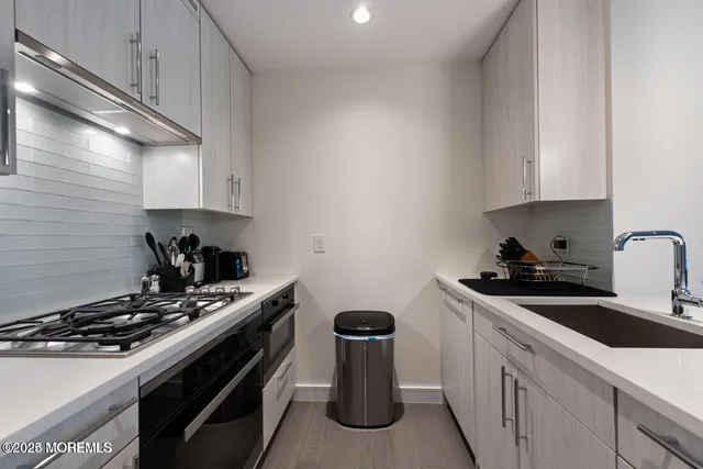 a kitchen with a stove and a sink