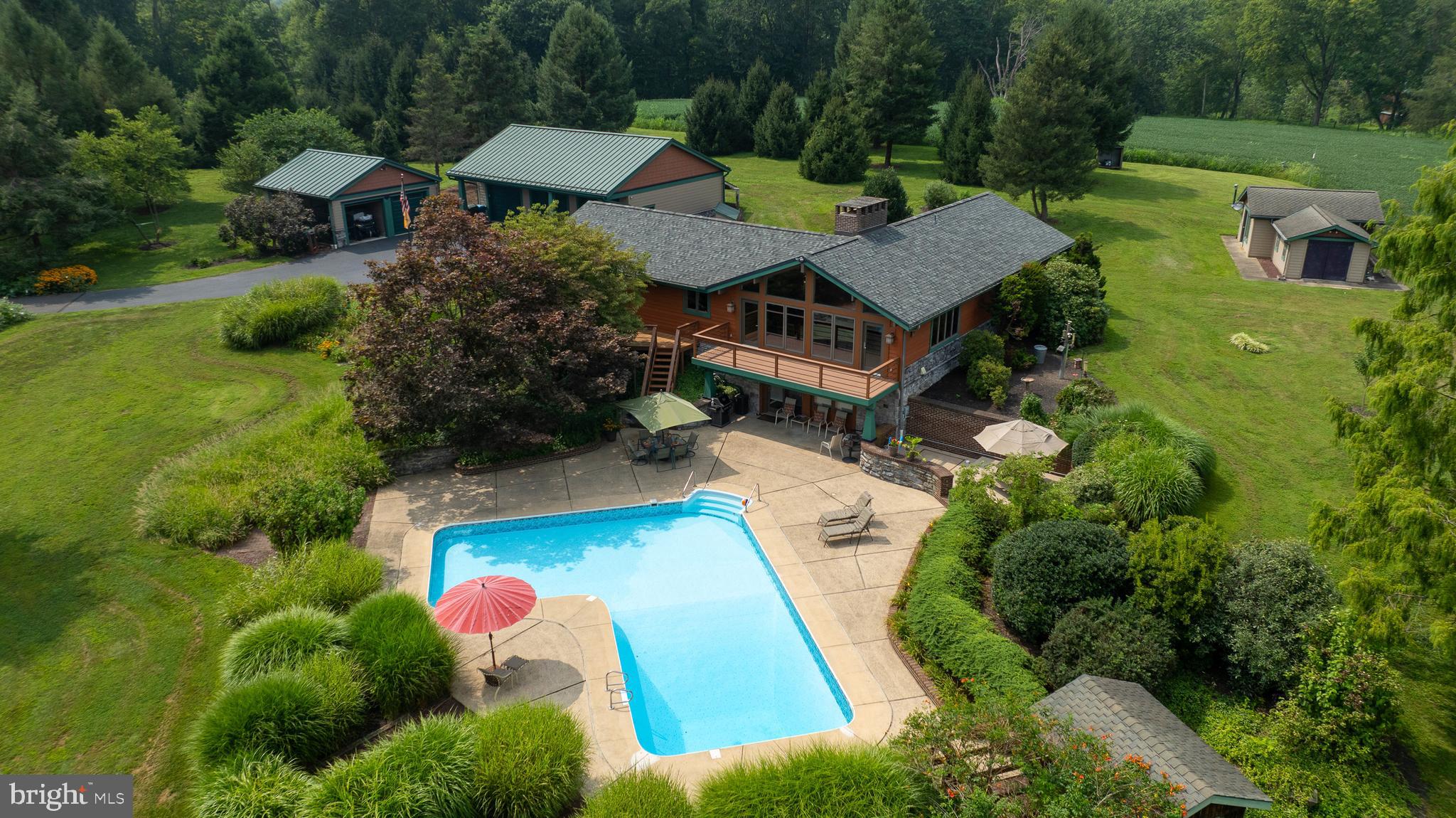an aerial view of a house with garden space and street view