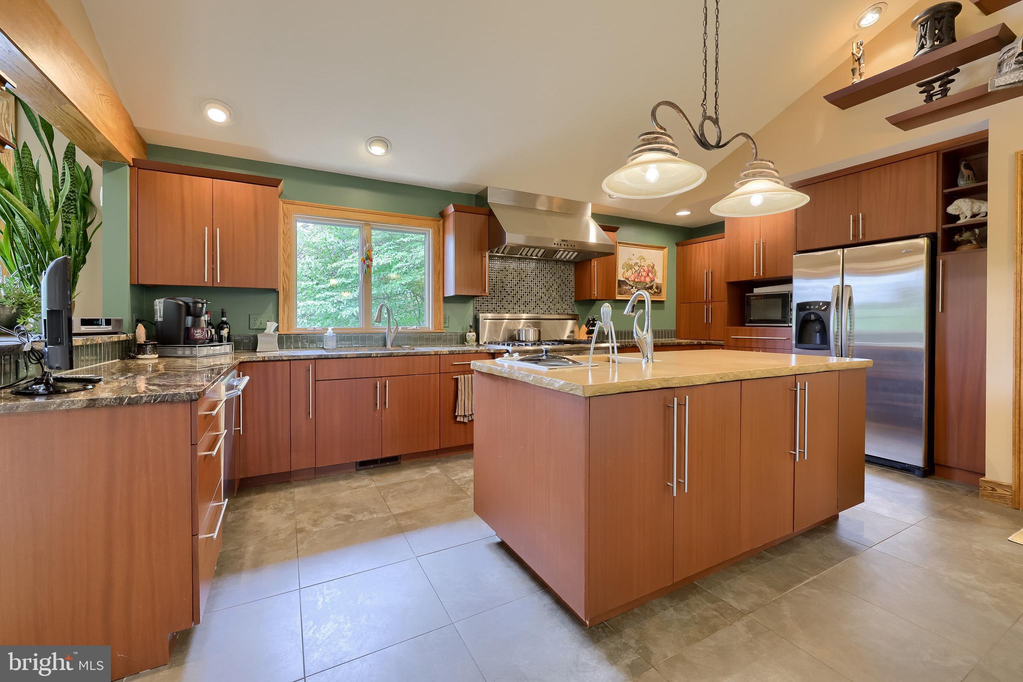 5776 Pheasant Run Road Hellam, PA 17406 - Photo 13 of 56 a kitchen with stainless steel appliances kitchen island granite countertop a sink counter space cabinets and a large window