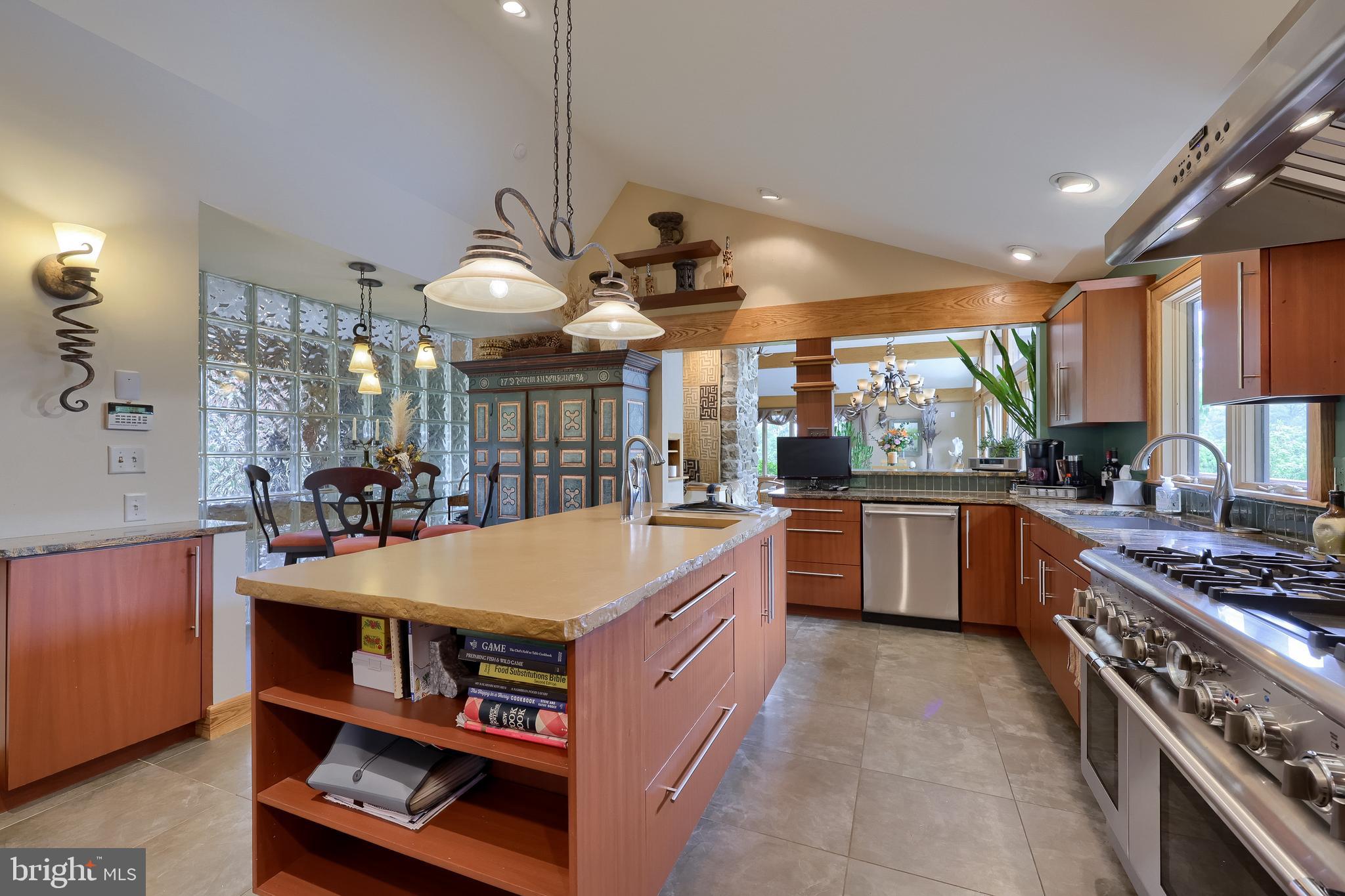 5776 Pheasant Run Road Hellam, PA 17406 - Photo 14 of 56 a kitchen with stainless steel appliances granite countertop a stove a sink dishwasher and a dining table with the view of living room