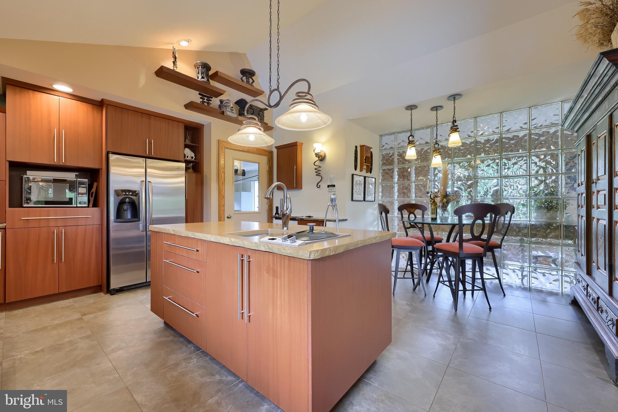 5776 Pheasant Run Road Hellam, PA 17406 - Photo 15 of 56 a kitchen with stainless steel appliances kitchen island granite countertop a table chairs and a chandelier