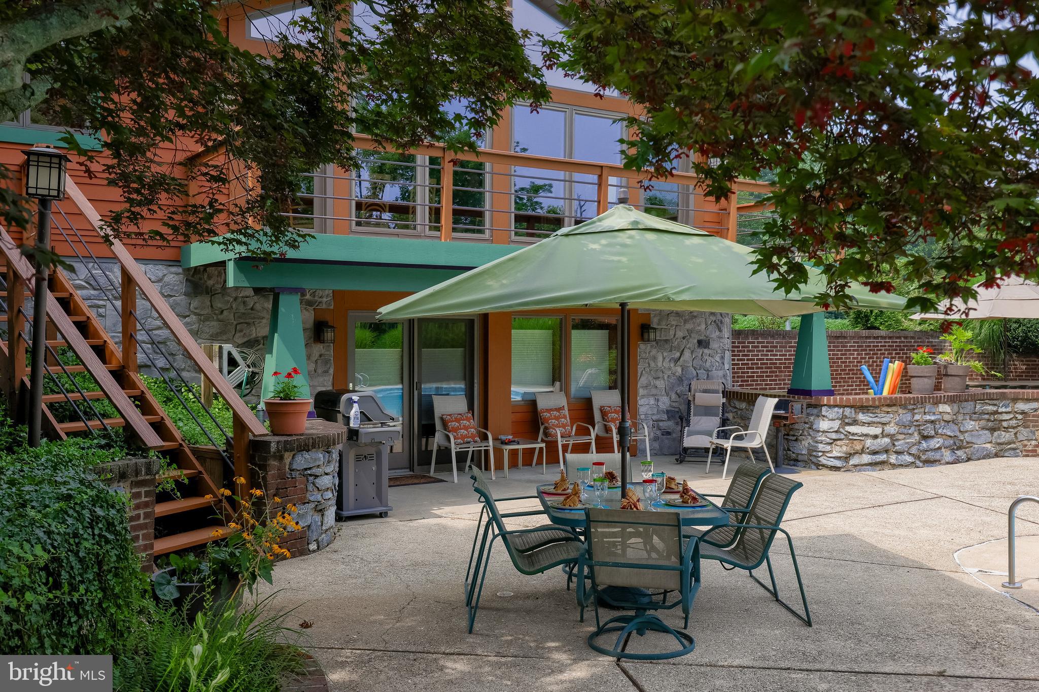 5776 Pheasant Run Road Hellam, PA 17406 - Photo 41 of 56 a view of patio with a table and chairs under an umbrella