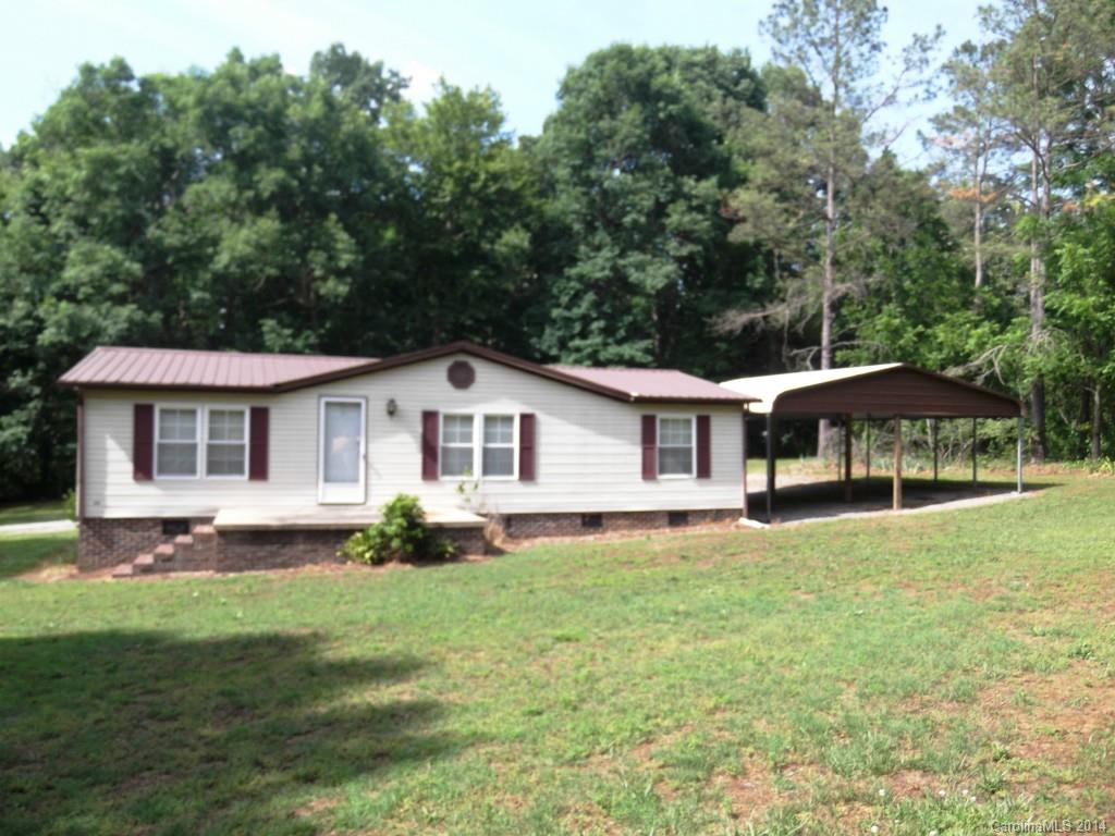 5664 Bill Sain Road Vale, NC 28168 - Photo 1 of 24 a white house covered with tall trees
