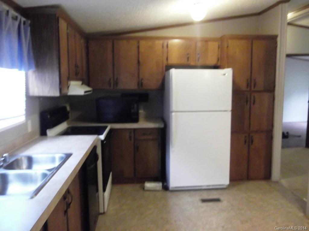 5664 Bill Sain Road Vale, NC 28168 - Photo 8 of 24 a kitchen with a refrigerator sink and cabinets